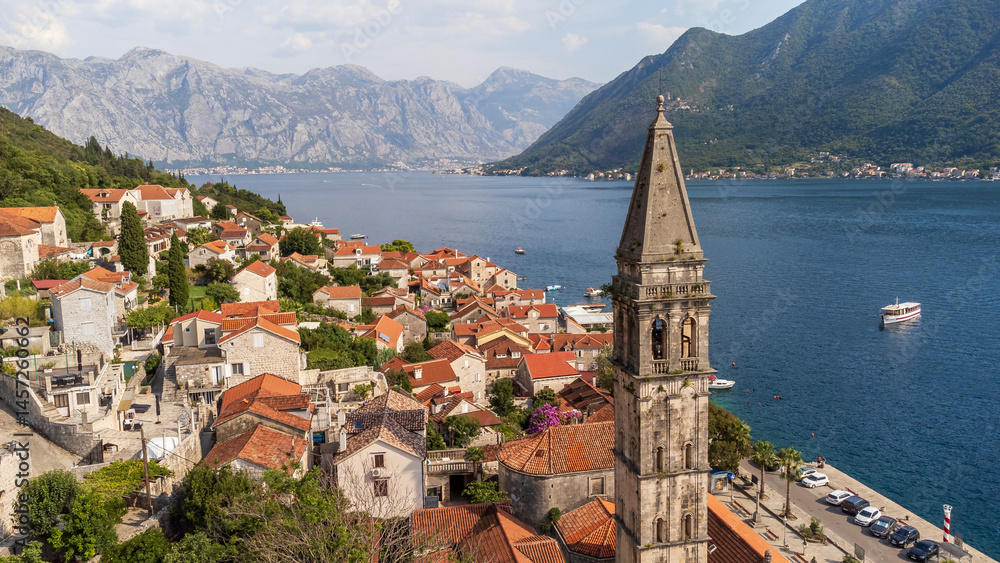 Fototapeta premium Aerial view of Perast city on a sunny day. Old venetian tourist town located in the Adriatic Sea coast in the Bay of Kotor, Montenegro