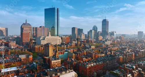 Flight above the remarkable old architecture of Boston. Approaching the beautiful modern high-rise buildings in the downtown. Aerial perspective on sunny day.