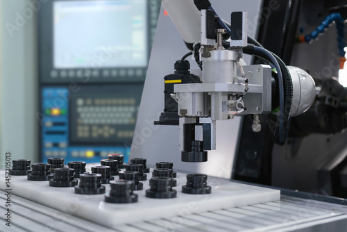 Close up industrial automation gripping robot working with metalwork on CNC machine on smart manufacturing and right copy space, industry 4.0 and modern technology