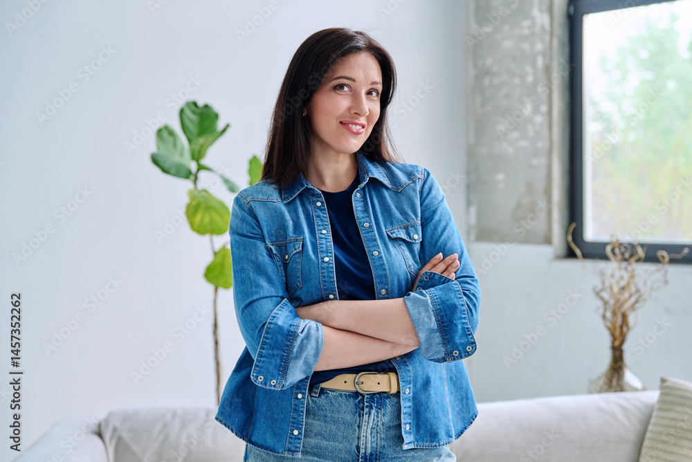 Portrait of beautiful young confident woman in home interior