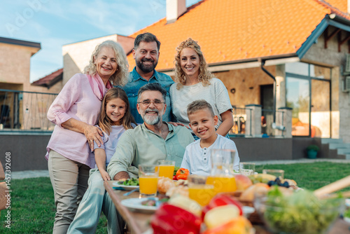 Happy family enjoying backyard meal together at home