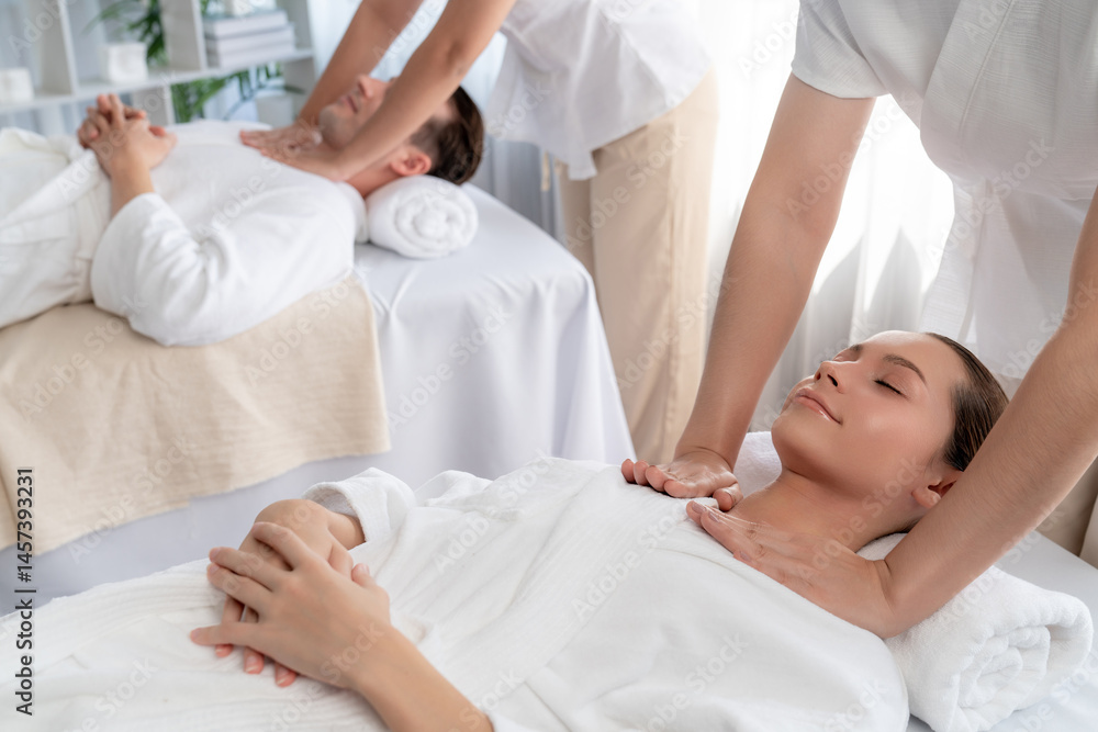 Caucasian couple customer enjoying relaxing anti-stress spa massage and pampering with beauty skin recreation leisure in day light ambient salon spa at luxury resort or hotel. Quiescent Caucasian couple customer enjoying relaxing anti-stress spa massage and pampering with beauty skin recreation leisure in day light ambient salon spa at luxury resort or hotel. Quiescent