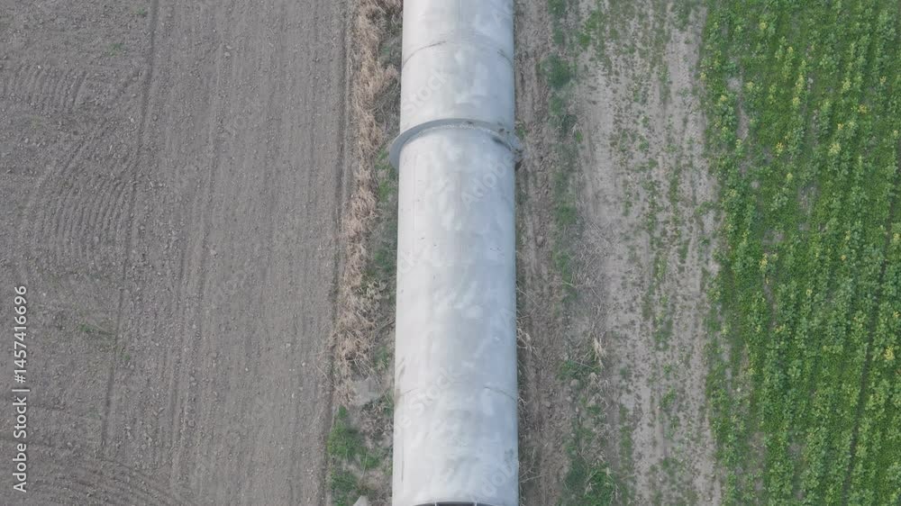 Aerial view of irrigation pipeline from dam in valley at sunset Aerial view of irrigation pipeline from dam in valley at sunset