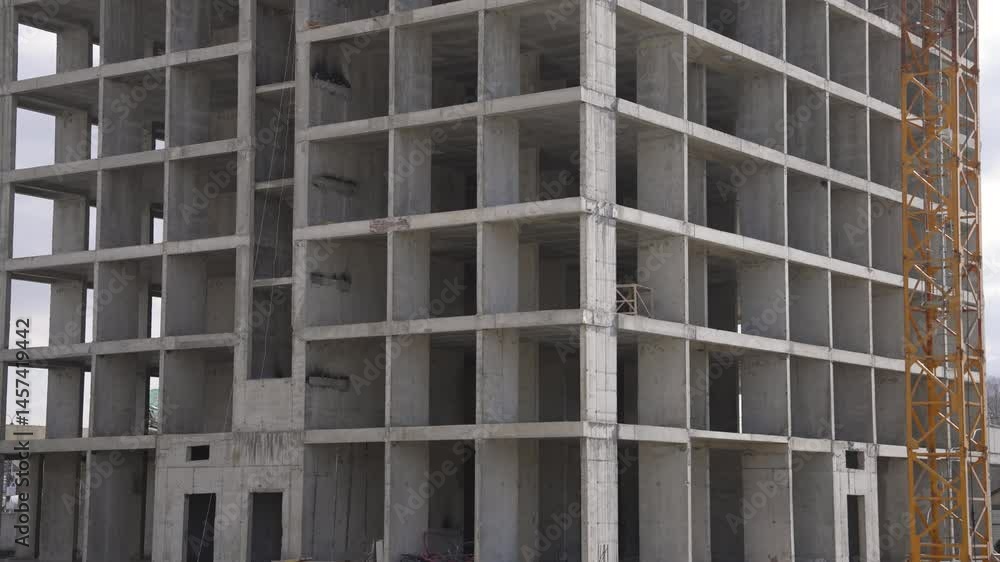 Concrete building skeleton rising floor by floor on a construction site, showcasing ongoing progress Concrete building skeleton rising floor by floor on a construction site, showcasing ongoing progress
