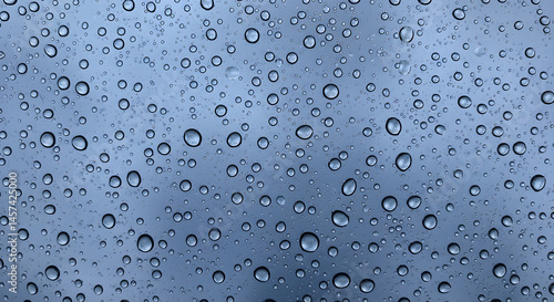Water Droplets On Glass Surfaces Reflecting A Cloudy Sky Pattern