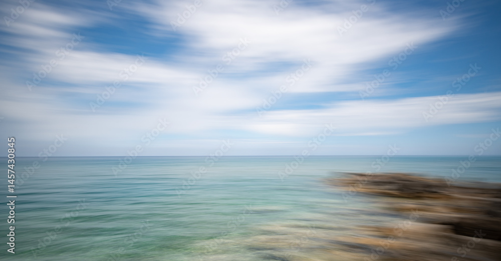 Blurred ocean horizon with dynamic sky movement