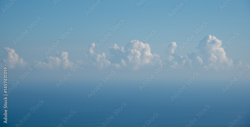 Majestic clouds hovering above tranquil ocean horizon