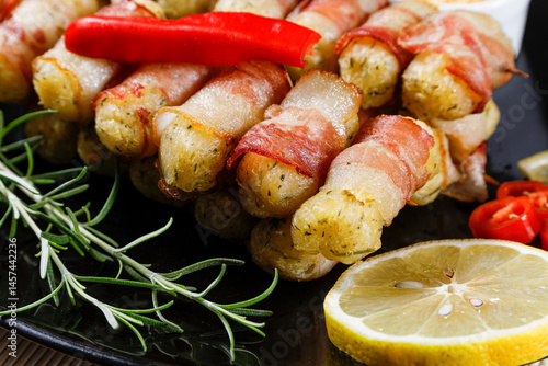 Cuadro en lienzo Cassava skewers wrapped in bacon, cassava medallion.