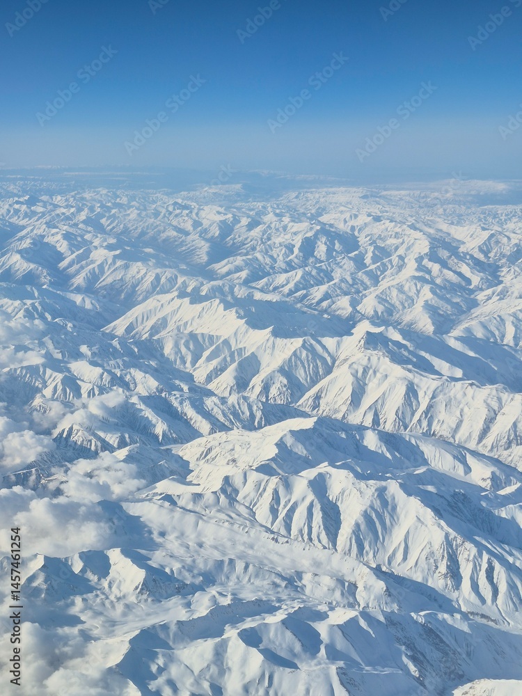 Fototapeta premium Beautiful mountain view from a plane in winter
