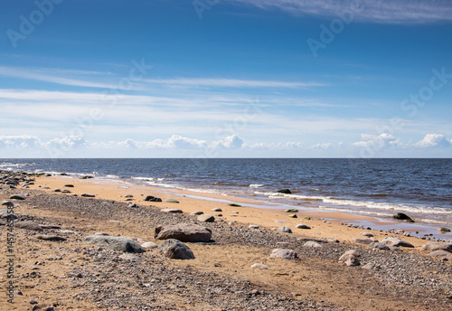 The rocky shore of the Gulf of Riga in the Baltic Sea in Latvia on a sunny May day.