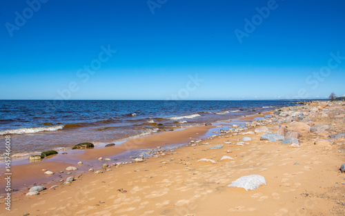 The rocky shore of the Gulf of Riga in the Baltic Sea in Latvia on a sunny May day