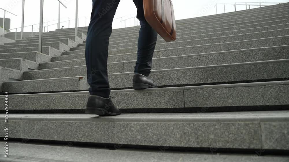 Top view of smart business man walking up stairs with bag in the hand. Professional project manager climb up the stair and going to workplace. Increasing skill, getting promotion, traveling. Exultant.