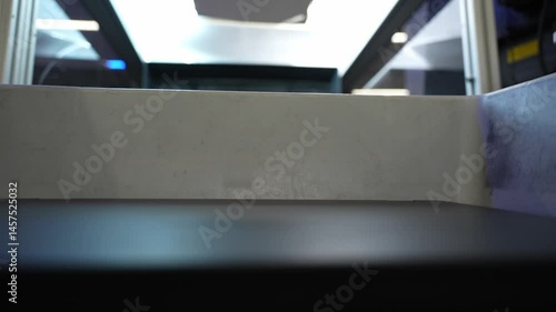 Airport security screening bin passing through an x-ray machine.