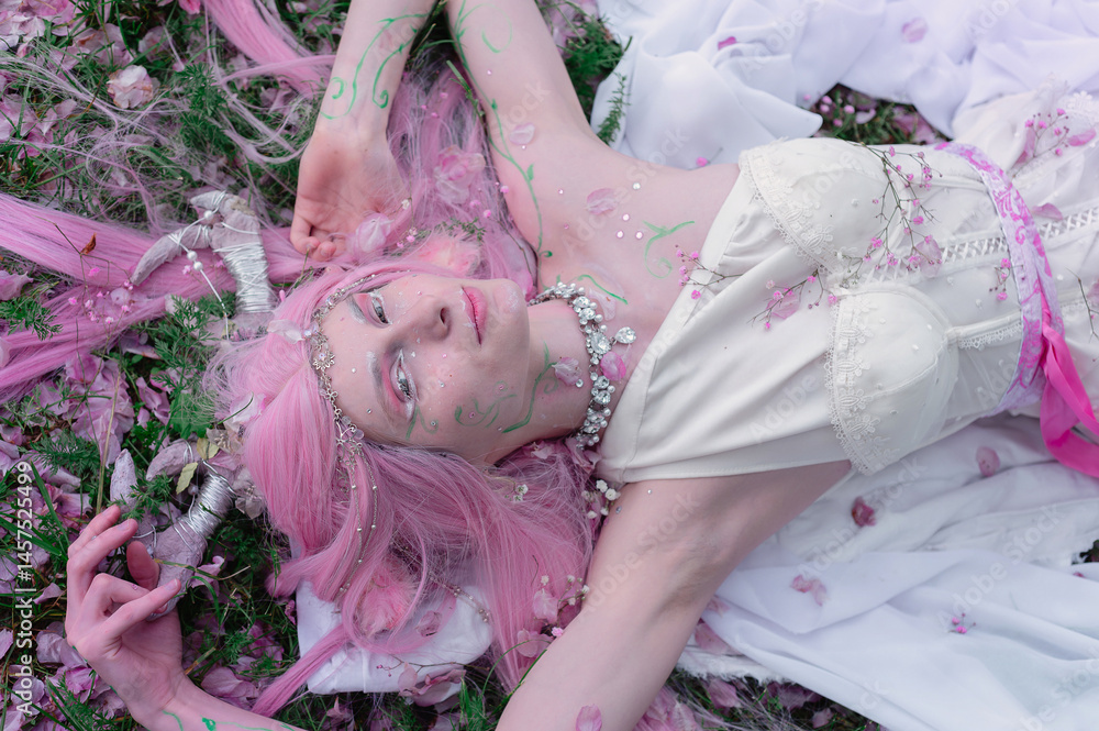 Deer dryad girl against the background of a blooming pink apple tree