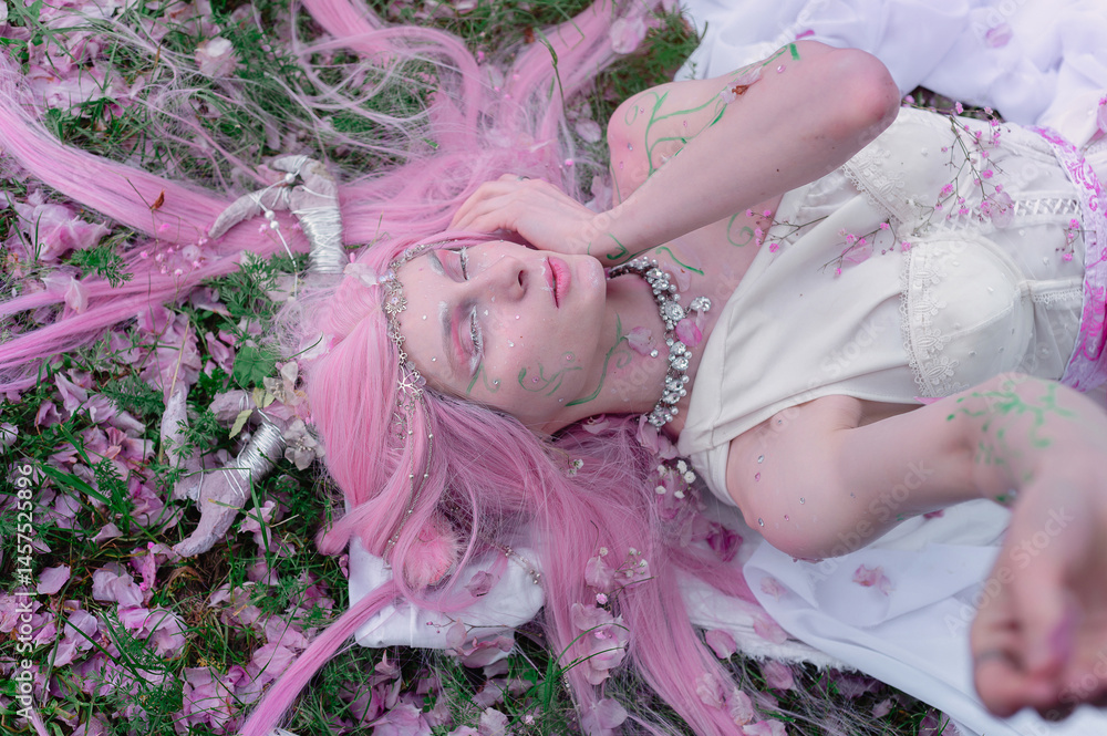 Deer dryad girl against the background of a blooming pink apple tree