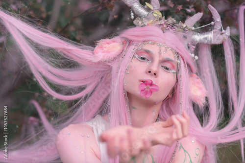 Obraz na płótnie Deer dryad girl against the background of a blooming pink apple tree w salonie