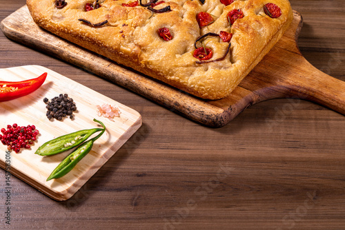 Traditional Italian Focaccia with cherry tomatoes, black olives and rosemary.
