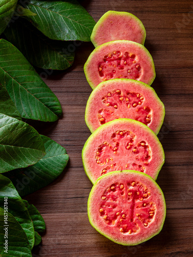 Beautiful fresh red guava, autumn fruit on wooden rustic background.