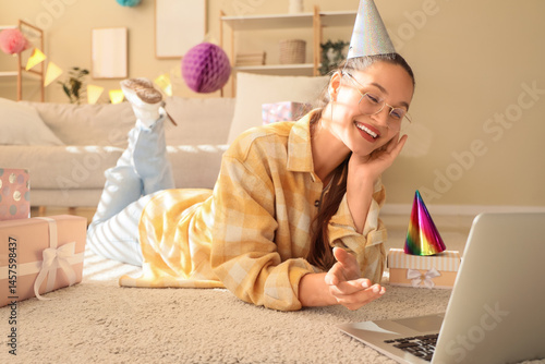 Young woman in party hat wi...