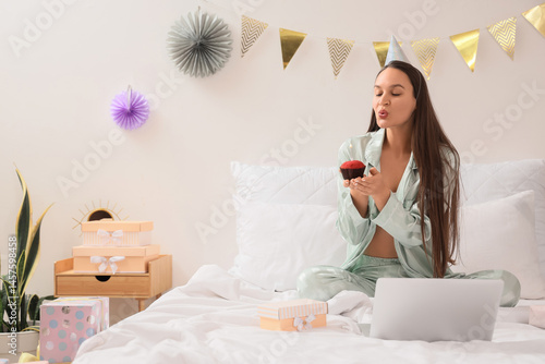 Young woman with muffin and...