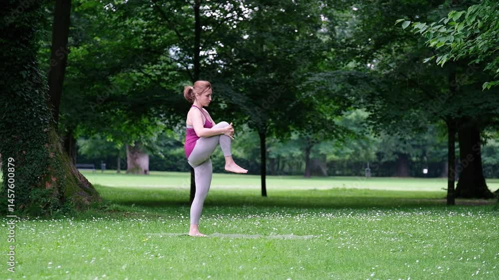4K video of Woman in tank top and light leggings practices yoga in serene forest setting, performing deep stretch on lush green lawn. Peaceful environment enhances her focus and connection with nature 4K video of Woman in tank top and light leggings practices yoga in serene forest setting, performing deep stretch on lush green lawn. Peaceful environment enhances her focus and connection with nature