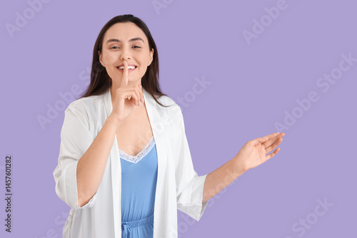 Young woman in pajamas show...