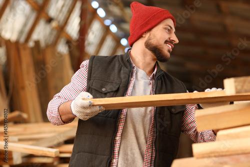 Young carpenter with wooden...