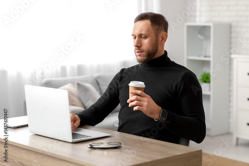 Young man with cup of coffe...