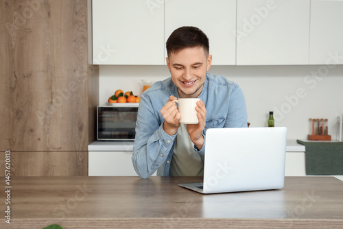 Handsome young man with mug...