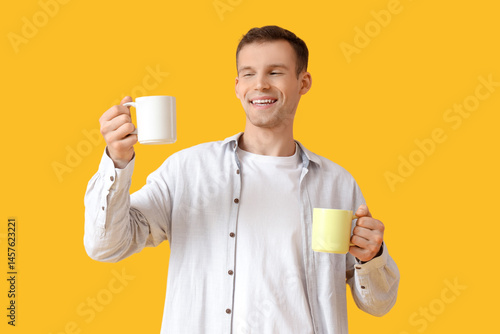 Handsome young man with cup...