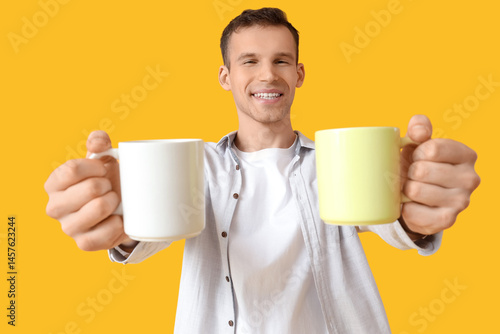 Handsome young man with cup...