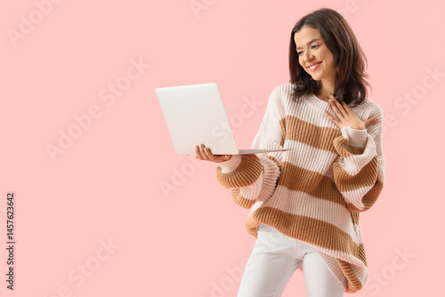 Young woman with laptop vid...