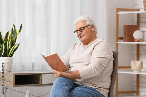 Handsome senior man reading...