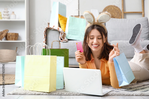 Young woman in bunny ears w...