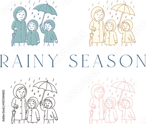 雨具を着て傘をさしている家族