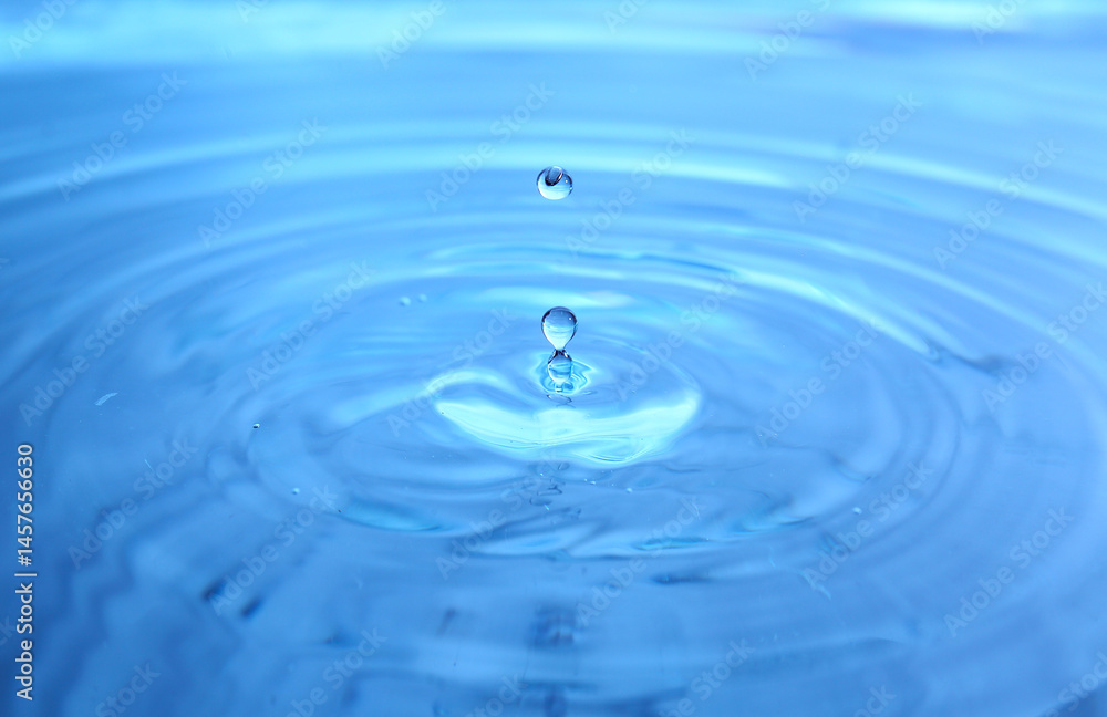 Splash of water on blue background, closeup Splash of water on blue background, closeup