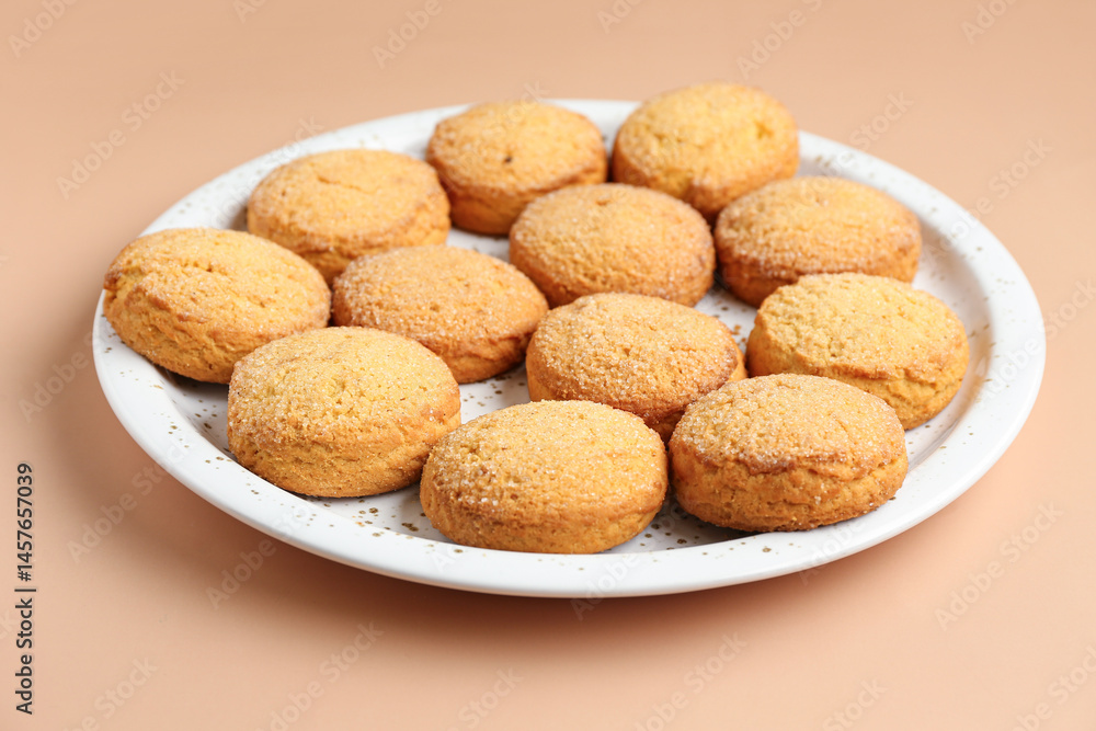 Plate with sweet cookies on brown background, closeup Plate with sweet cookies on brown background, closeup