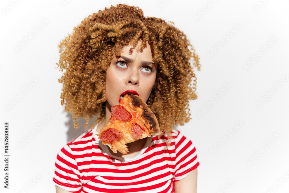 Young woman with curly hair enjoying a slice of pizza, wearing a striped shirt, playful expression, minimalist background showcasing a vibrant and tasty concept