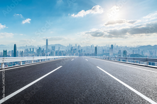 Straight asphalt road and city skyline with modern buildings in Shenzhen