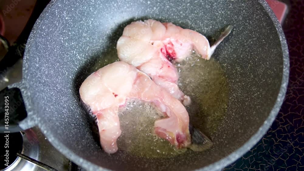 fish frying in hot oil in a frying pan. High quality 4k footage fish frying in hot oil in a frying pan. High quality 4k footage