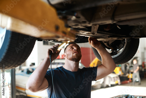 Canvas Print Torch, inspection and mechanic with vehicle in workshop for service, maintenance or repair for safety