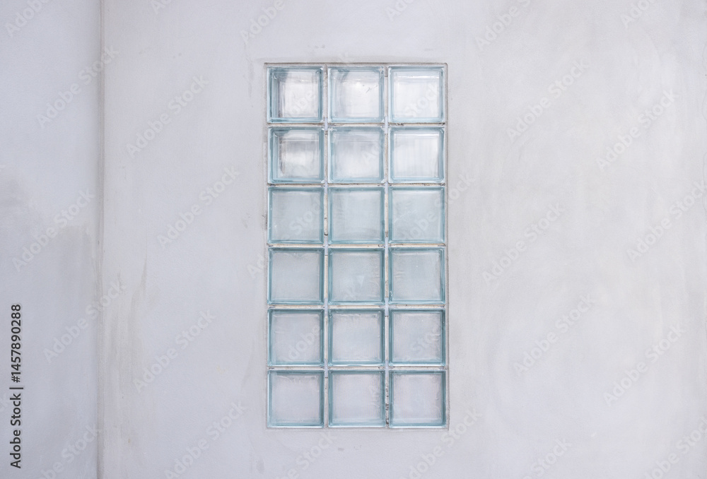 Fototapeta premium Building exterior under construction consist of concrete wall plastering and transparent glass block for light go inside building. Include empty coppy space for add text.