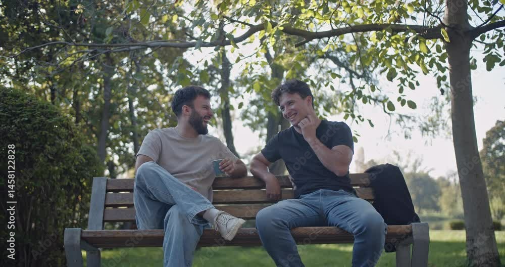 Two friends enjoy a relaxing afternoon, chatting and sharing stories on a park bench under the shade of a tree. Two friends enjoy a relaxing afternoon, chatting and sharing stories on a park bench under the shade of a tree.