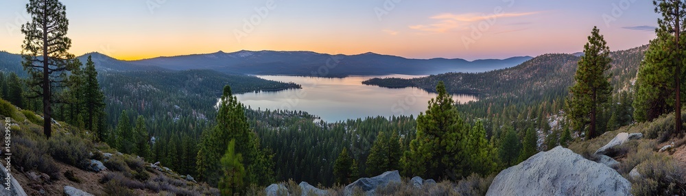Panoramic view of a serene lake nestled in a mountain valley at dawn.