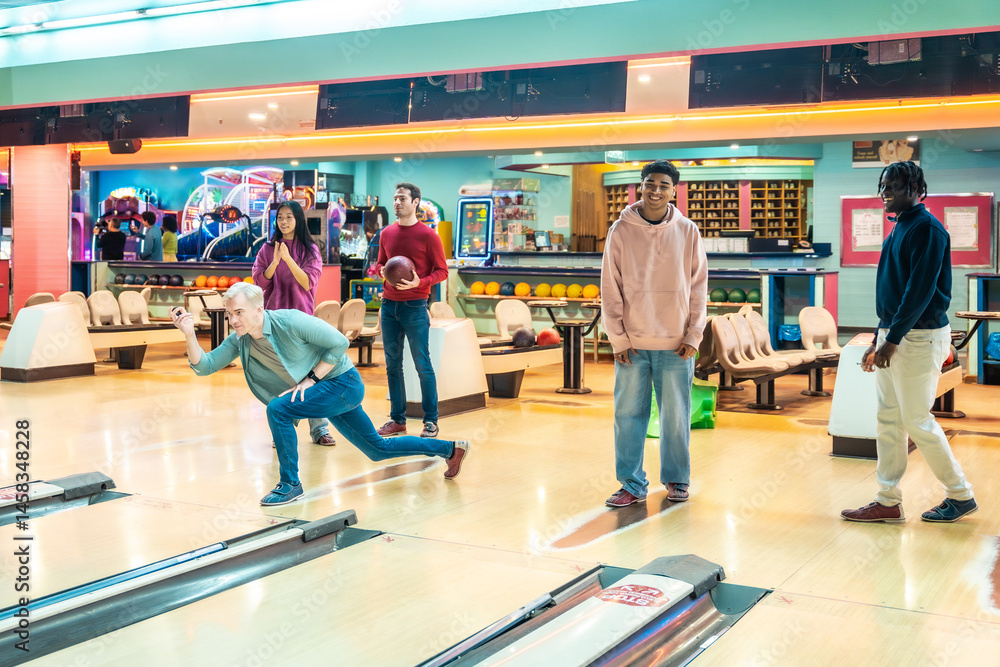 Friends playing bowling together in a bowling alley