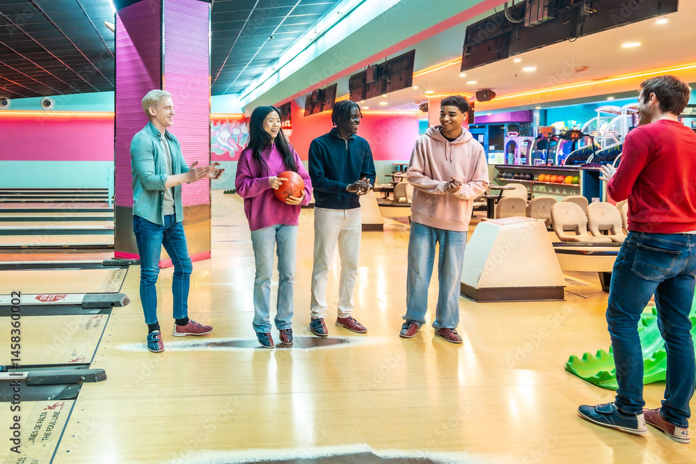 Young multiethnic friends enjoying bowling together at the bowling alley