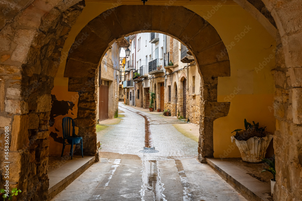 Passageway with stone arches under the houses of Rafales, a medieval village in the region of Matarrana, Teruel.