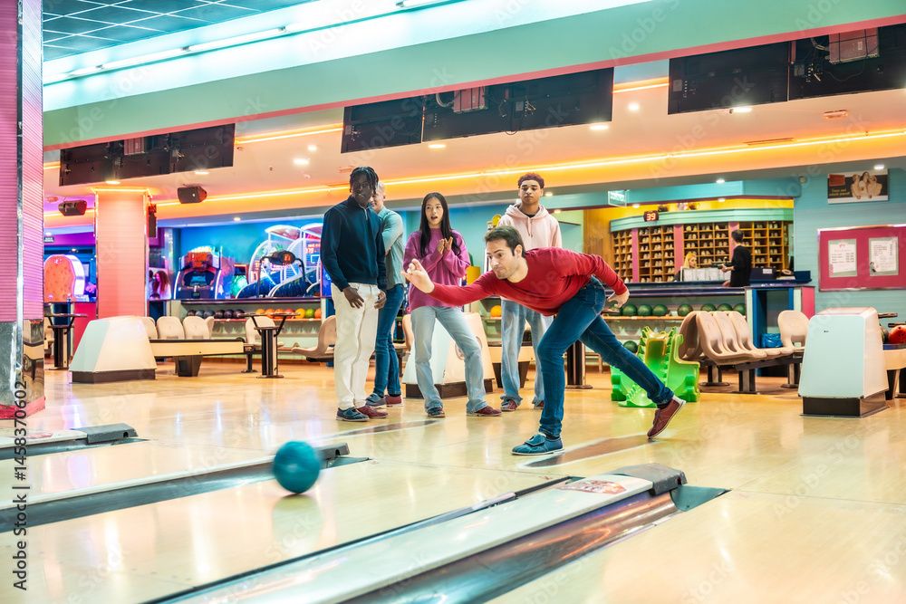 Friends playing bowling together in bowling alley