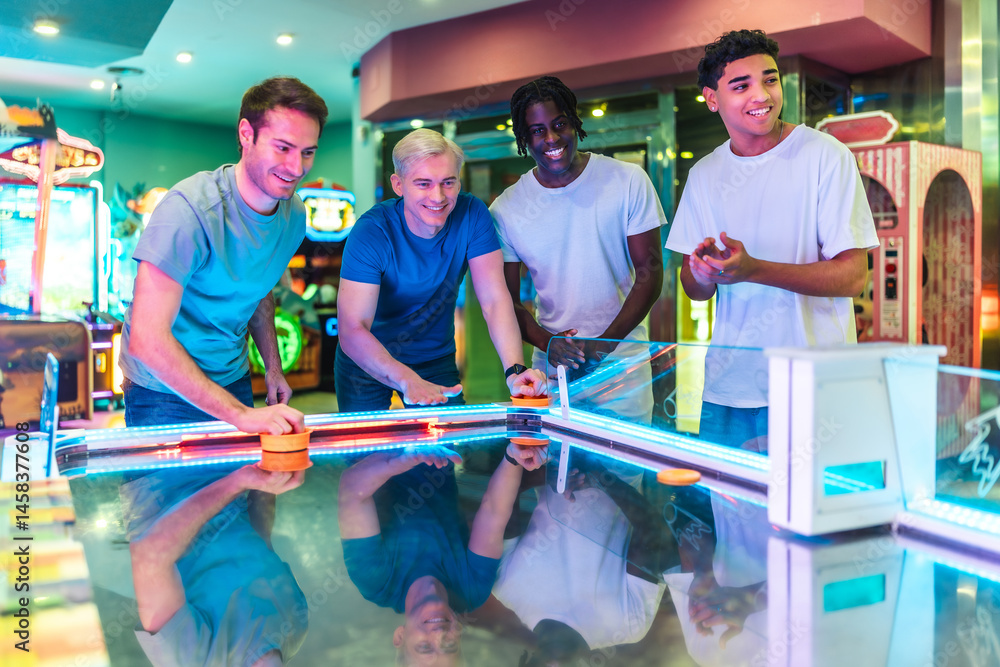 Friends playing air hockey in entertainment center