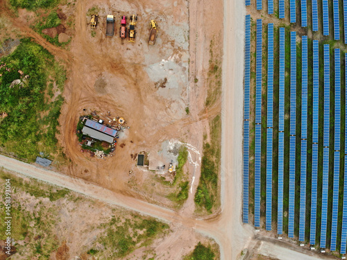 Solar construction site with a boabab tree in Malawi, Africa. It is a 20 mega watt farm under construction. The boabab tree was kept and the solar farm was designed around it.